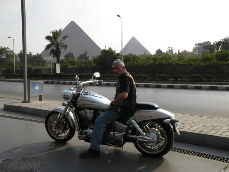 Peace and brotherhood advocate Mario Nieves poses in front of the Pyramides in Egypt during his travels to promote peace among nations. Photo courtesy of Mario Nieves