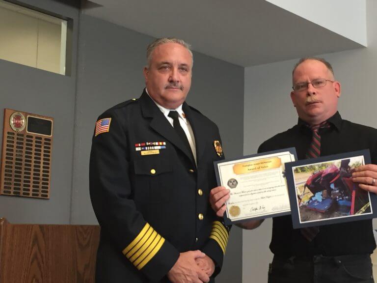 Citizen Robert Schelfelbein displays the certificates he received from OFPD Fire Chief Mike Schofield.