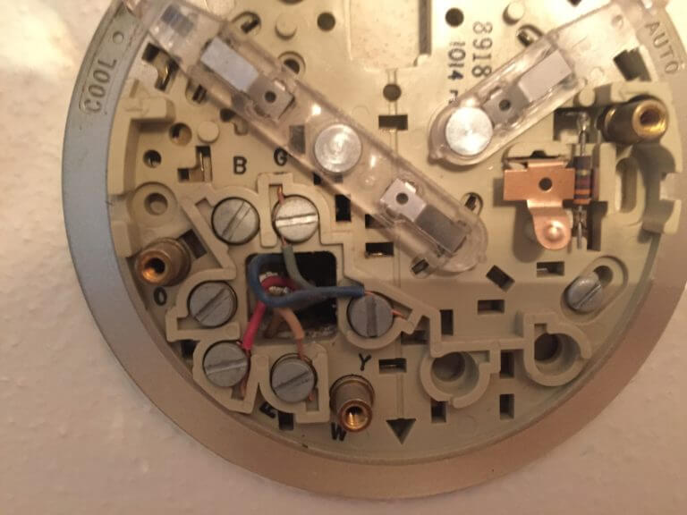 Old round thermostat wiring base that you will replace to install the Honeywell Lyric Round