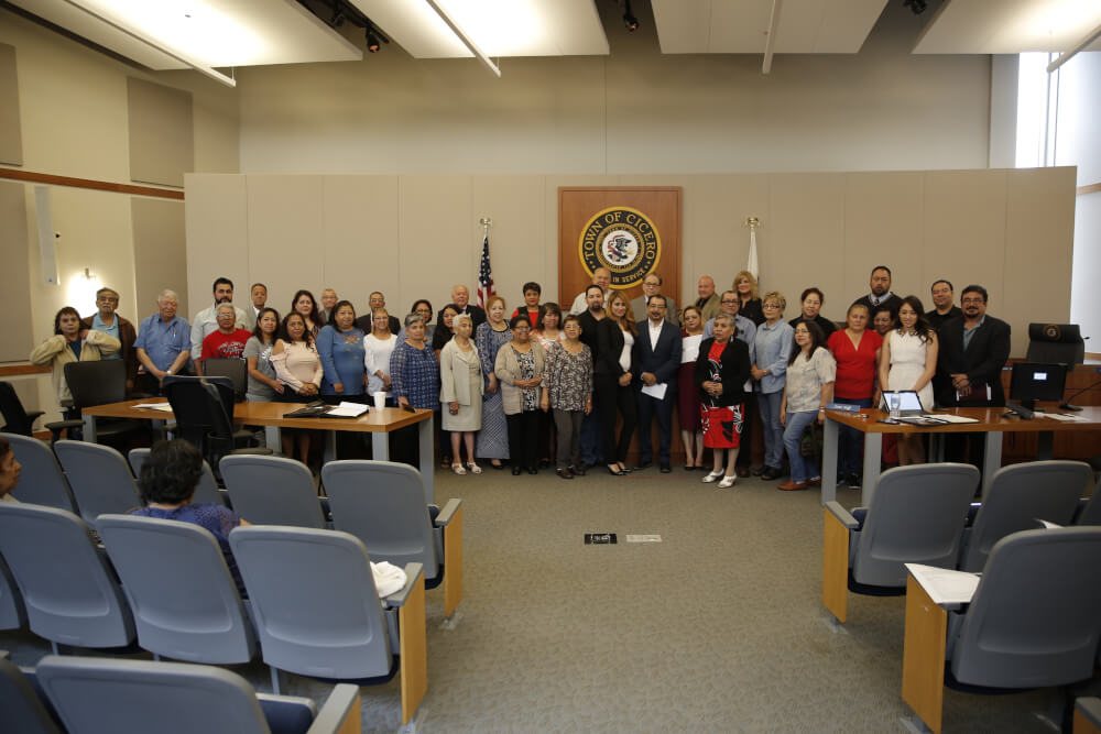 About two dozen immigrants who were sworn in as citizens this year returned to Cicero Town Hall Tuesday, June 12, 2018 to thank officials of the Town of Cicero for providing the guidance and education to help become U.S. citizens. Photo courtesy of the Town of Cicero and Gerardo Lopez.