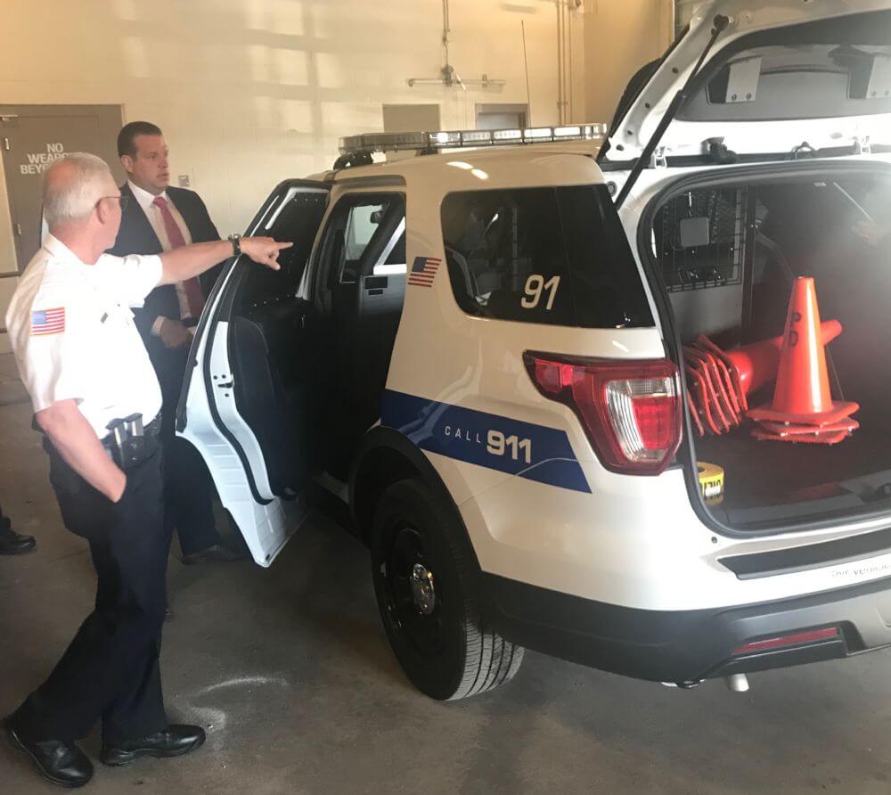 Lyons Police Chief James Keating and Mayor Christopher Getty check out one of the new vehicles bought for the department. (Photo by Steve Metsch)