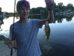 Young fisherman catches a decent size Perch at Candlewick Lake in Northern Illinois
