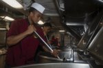 PHOTO CAPTION: 200426-N-ZE328-1089 ATLANTIC OCEAN (April 26, 2020) Culinary Specialist 3rd Class Jeriel Butler, from Chicago, stirs cheese sauce in the aft galley aboard the Nimitz-class aircraft carrier USS Harry S. Truman (CVN 75) in the Atlantic Ocean April 26, 2020. The Harry S. Truman Carrier Strike Group (HSTCSG) remains at sea in the Atlantic as a certified carrier strike group force ready for tasking in order to protect the crew from the risks posed by COVID-19, following their successful deployment to the U.S. 5th and 6th Fleet areas of operation. Keeping HSTCSG at sea in U.S. 2nd Fleet, in the sustainment phase of OFRP, allows the ship to maintain a high level of readiness during the global COVID-19 pandemic. (U.S. Navy photo by Mass Communication Specialist Seaman Kelsey Trinh)