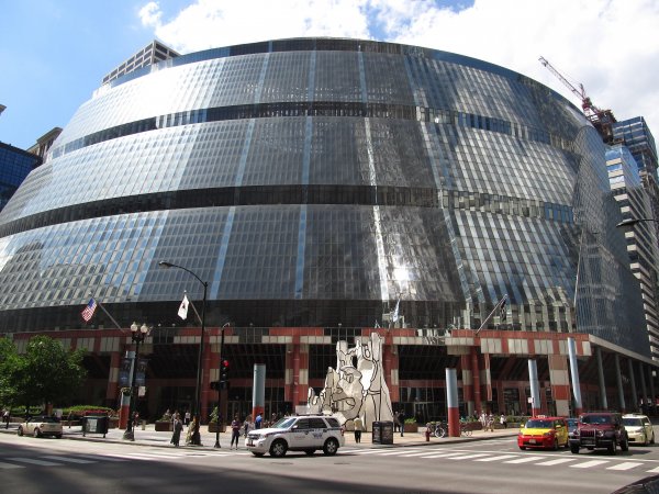      James R. Thompson Center, Chicago, Illinois (9179428785).jpg More details The James R. Thompson Center (JRTC) is located at 100 W. Randolph Street in the Loop, Chicago, Illinois and houses offices of the State of Illinois. The building opened in May 1985 as the State of Illinois Center. It was renamed in 1993 to honor former Illinois Governor James R. Thompson. The property takes up the entire block bound by Randolph, Lake, Clark and LaSalle Streets, one of the 35 full-size city blocks within Chicago's Loop. In front of the Thompson Center is a sculpture, Monument With Standing Beast, by Jean Dubuffet. The JRTC is sometimes referred to as the State Building. The JRTC was designed by Murphy/Helmut Jahn and opened to mixed reviews by critics, ranging from "outrageous" to "wonderful". The color of the street-level panels was compared to tomato soup. The 17-story, all-glass exterior does not reflect the building's function, and instead conveys an image of pure postmodernism; the effect is striking, especially from the Daley Center.[citation needed] Visitors to the JRTC's interior can see all 17 floors layered partway around the building's immense skylit atrium. The open-plan offices on each floor are supposed to carry the message of "an open government in action." Photo courtesy of Wikipedia