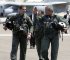 President George W. Bush walks across the tarmac with NFO Lt. Ryan Phillips to Navy One, an S-3B Viking jet, at Naval Air Station North Island in San Diego Thursday, May 1, 2003. Flying to the USS Abraham Lincoln, the President addressed the nation and declared "Mission accomplished" in Iraq to justify diverting forces from Afghanistan. Photo courtesy of Wikipedia