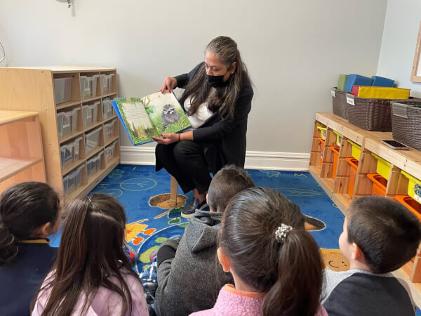 Archer Heights and SEIU HCII child care provider, Laura Maldonado, reading to children in her early childhood care program. Photo courtesy of Congresswoman Marie Newman