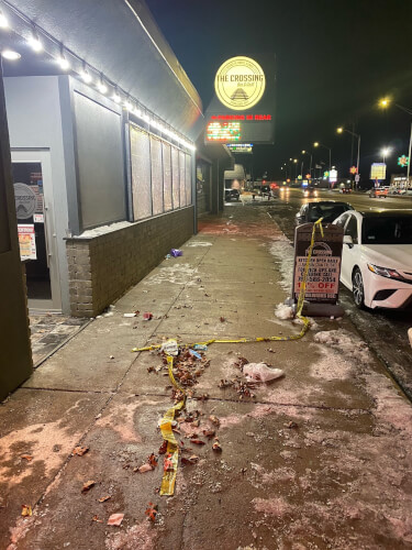 Police tape lies on the ground in front of the now closed Crossing Bar and Grill. (File photo courtesy of the Southwest News Newspaper Group)
