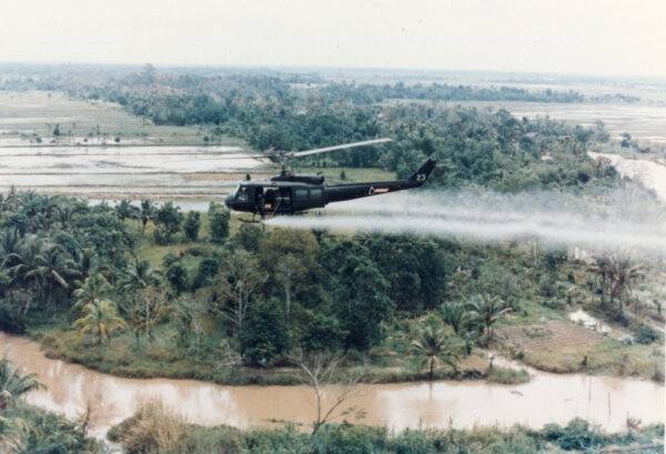US Huey helicopter sprays Agent Orange in Vietnam. Photo courtesy of Wikipedia