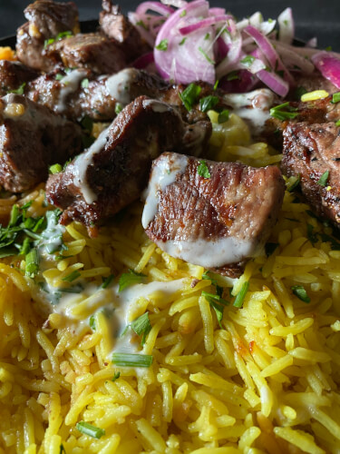 Classic and great tasting Shish Kabob plate with skewers of beef, lamb, and kuftah on a bed of yellow and red rice at Zwar in Orland Park. Photo courtesy of Ray Hanania