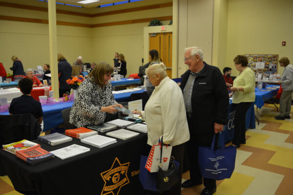 Residents meeting with the Cook County Sheriff's Office at the 2019 Senior Health Fair.