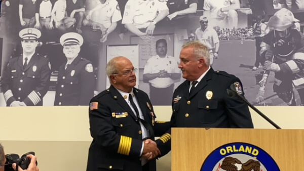 Former Orland Fire Protection District Chief Robert M. Buhs is congratulated by Fire Chief Michael Schofield at a dedication in Buhs honor July 15, 2022. Photo courtesy of Steve Neuhaus
