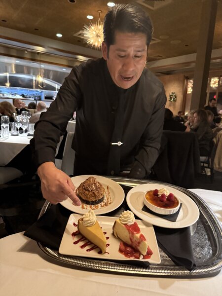 Sullivan's Steakhouse server Jairo with desserts