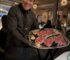 Sullivan's Steakhouse server Jairo with plate of steak options