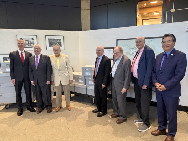 Former Congressman Dan Lipinski, Northwestern University President Henry Bienen, former Congressman Bill Lipinski, former Congressman Peter DeFazio, Joseph Schofer, Mayor David Brady, and Northwestern Library Dean Xuemao Wang pose with boxes of documents. Photo courtesy Ray Hanania
