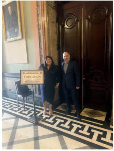 Senator Graciela Guzmán and Dr. Federico Luque Macías outside the Illinois Senate Education Committee hearing room, Springfield, May 5, 2026.
